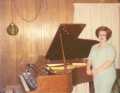 Nancy Leediker by her baby grand piano. Approx 1971-72